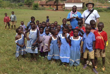 Fr. Charles Brown of the US Province with school children in Cameroon. For the founder, education was a path toward social change.