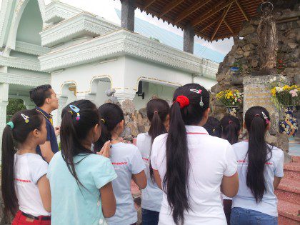 James prays before a statue of Mary with girls from the house. He says that the statue was "was found by fishermen under the Mekong River 33 years ago and is now dubbed by the people as 'Our Lady of the Mekong.'"