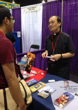 Fr. Quang at the SCJs' vocation booth at the Religious Education Conference