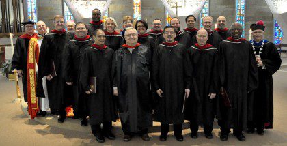 Fr. Steve (back, second from left) with SHSST graduates and administration.