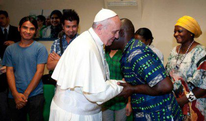 Pope Francis greets a refugee during a visit last September to Jesuit Refugee Service Italy's Centro Astalli (Alessia Giuliani/Jesuit Refugee Service)