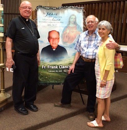 Fr. Mac with  Dr. Charlie Fox and wife Janie in front of a banner honoring Fr. Frank Clancy.  Dr. Fox is a retired surgeon who came to Hales Corners for Fr. Frank's funeral. "He remembersFr.  Frank as his best friend." said Fr. Mac.
