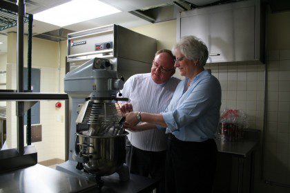 Dn. David and Barb Haag survey new kitchen equipment prior to the opening of Sacred Heart at Monastery Lake. Barb recently left her position as food services director at SHML.