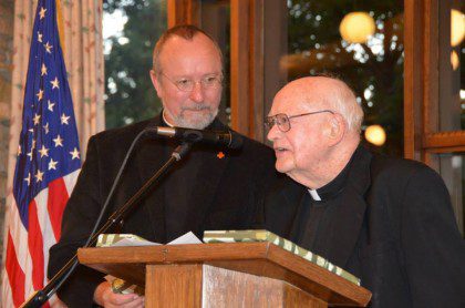 Fr. Frank (right) speaking at his 60th jubilee in 2013.